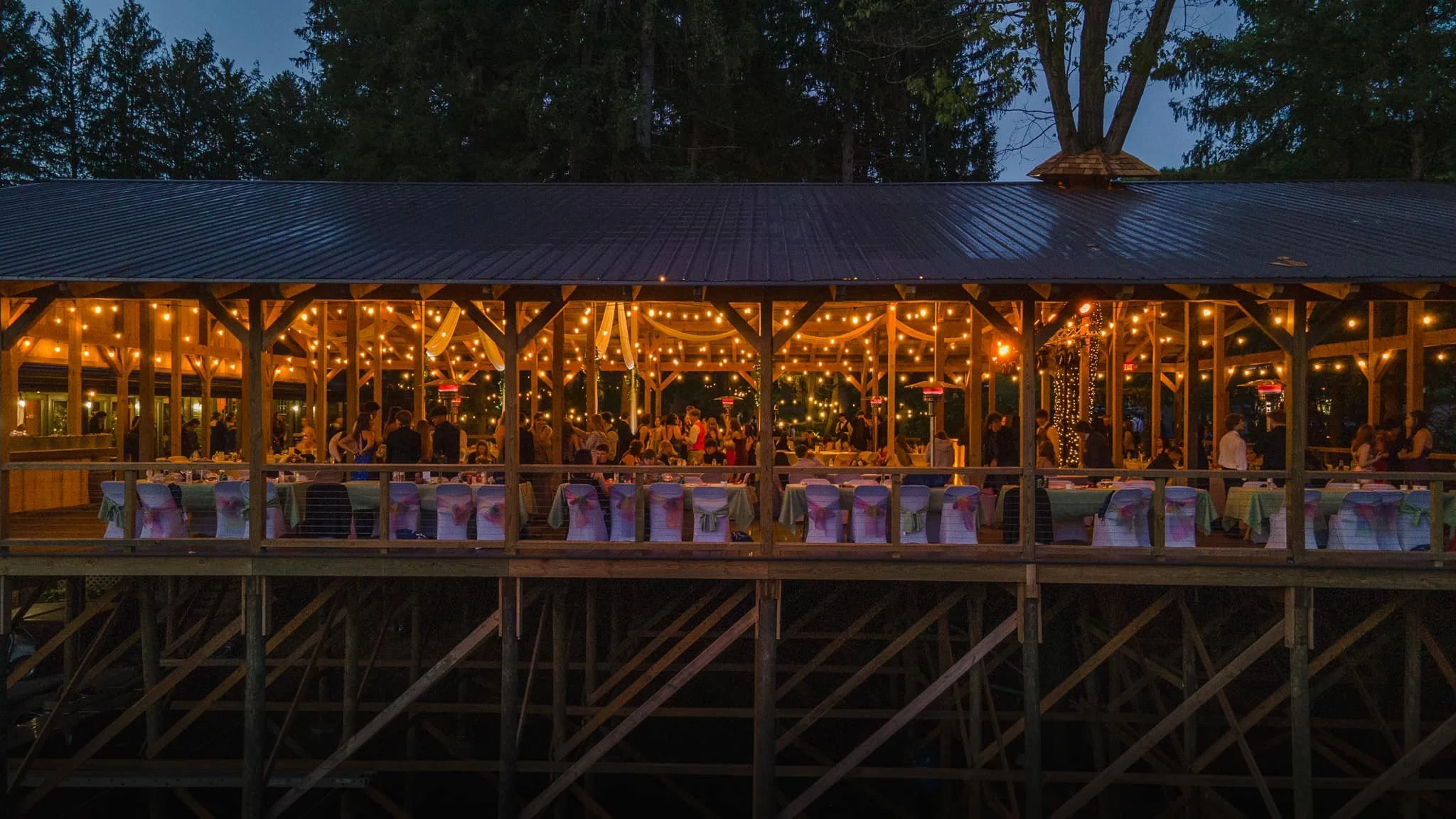 Cherry Run Lodge — outdoor pavilion lit with string lights at dusk